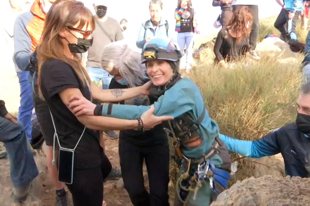 Beatriz Flamini, a Spanish mountaineer who has been isolated for 500 days in a cave in southern Spain, is greeted by teammates. Photo: Reuters