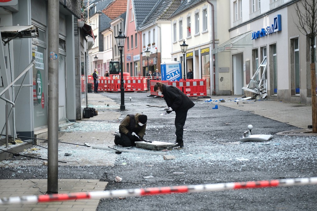 Law enforcement officers investigate the scene following an attack on bank ATMs in Ratingen, Germany on March 15, 2023. Photo: via Reuters
