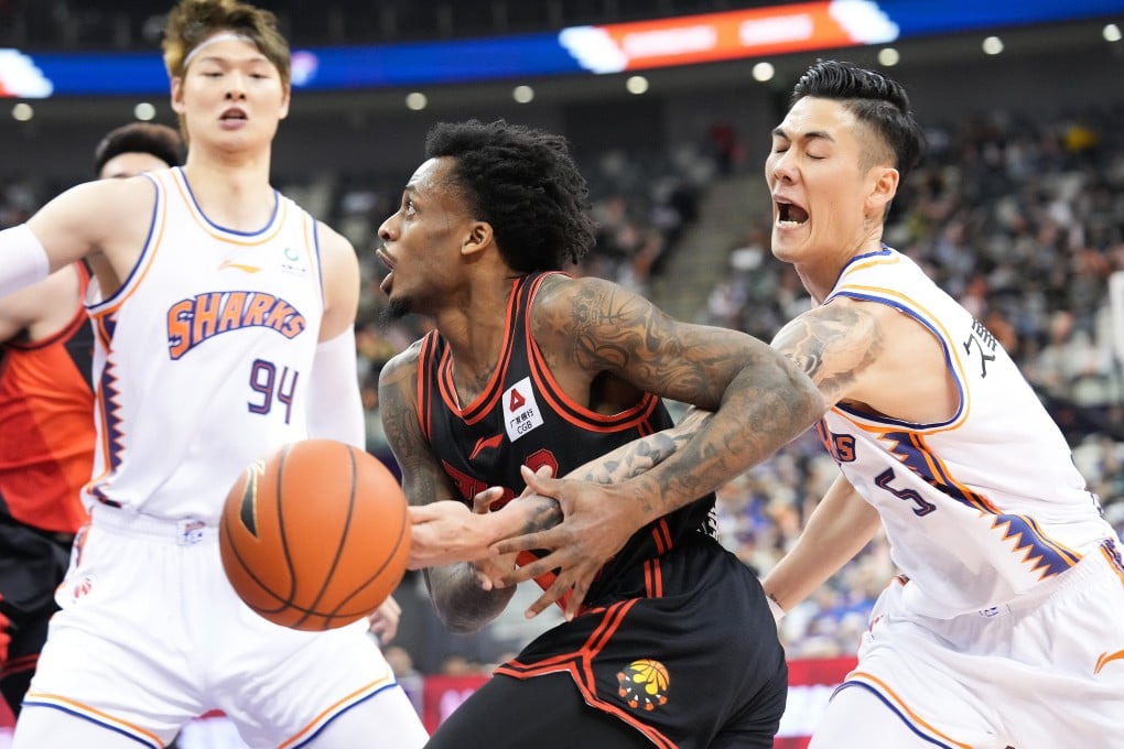 Antonio Blakeney (centre) of Jiangsu Dragons vies for the ball during a Chinese Basketball Association first round play-off match against Shanghai Sharks. Photo: Xinhua