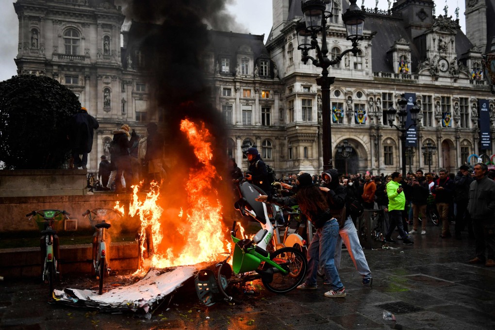 Protestors burn motocycles in front of the Hotel de Ville in Paris after France’s Constitutional Council approved the key elements of French President’s pension reform on Friday. Photo: AFP