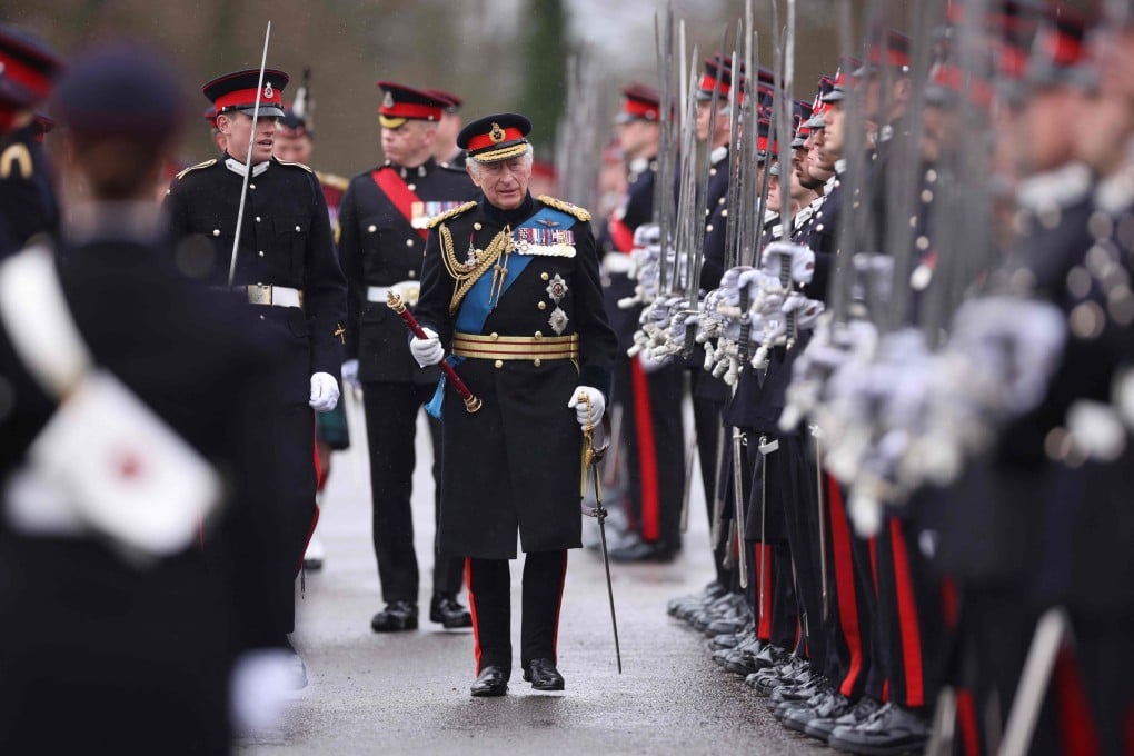 Britain’s King Charles III inspects graduating officer cadets in London on Friday. The new king’s coronation will take place on May 6. Photo: AFP