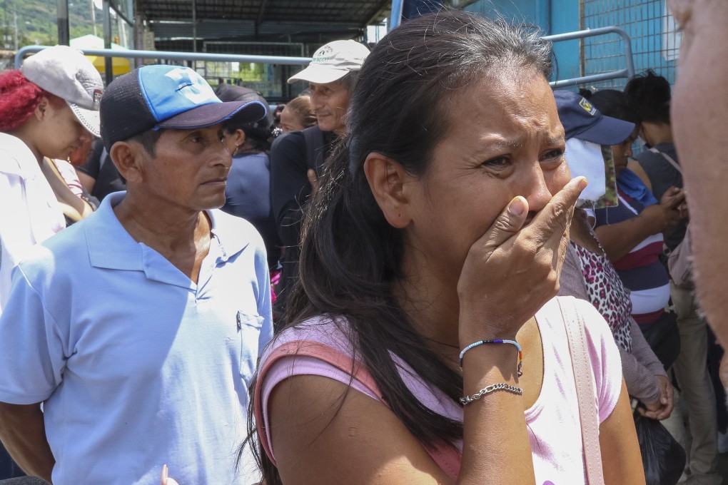 Relatives of inmates await information outside the Litoral Penitentiary in Guayaquil, Ecuador on Saturday after clashes broke out on Friday. Photo: EPA-EFE