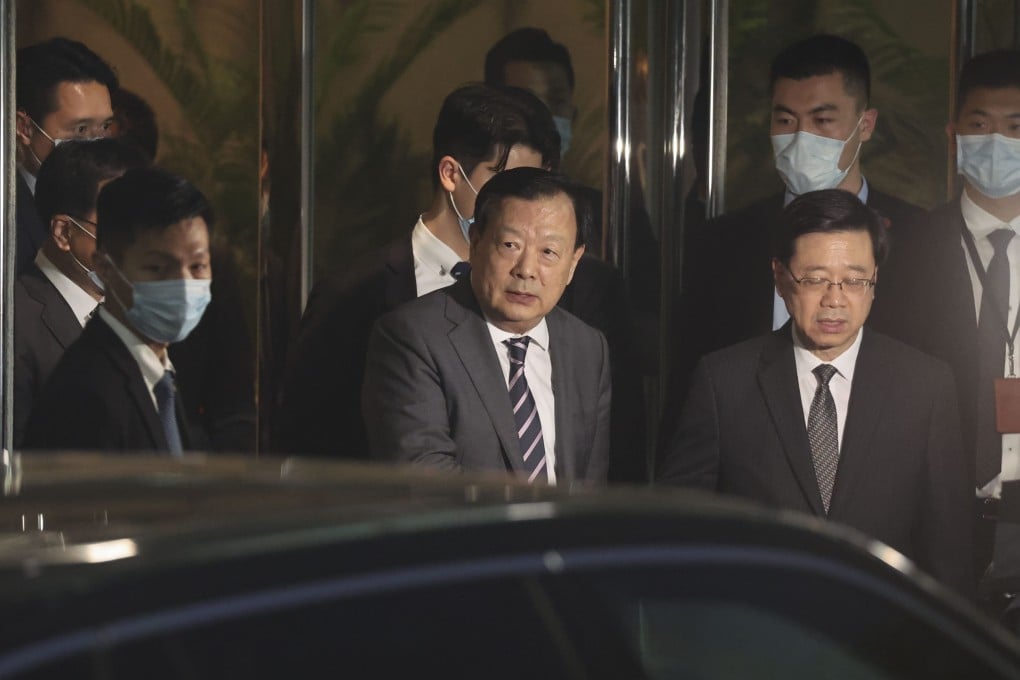 Xia Baolong, director of the Hong Kong and Macau Affairs Office (centre), and Chief Executive John Lee leave the liaison office in Sai Ying Pun on Friday. Photo: Edmond So