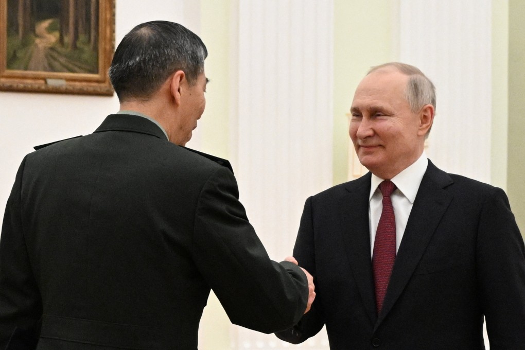 Russian President Vladimir Putin shakes hands with Chinese Defence Minister Li Shangfu during a meeting in Moscow, Russia on Sunday. Photo: Sputnik / Pavel Bednyakov / Pool via Reuters