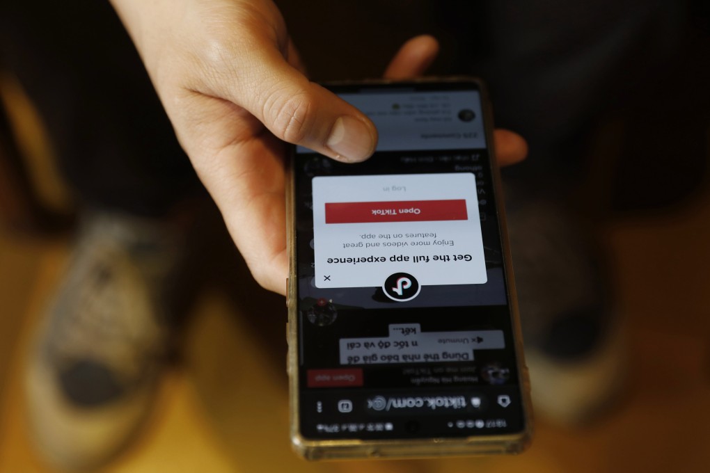 A man uses TikTok on his phone at a cafe in Hanoi, Vietnam, on April 6. Authorities in several countries, most notably the United States, have raised concerns about TikTok, its parent company ByteDance and its data privacy practices. Photo: EPA-EFE