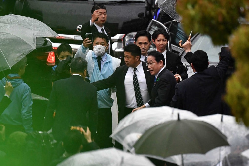 Japan’s Prime Minister Fumio Kishida is escorted by security officers at an election campaign event in Chiba prefecture on Saturday, hours after being evacuated unharmed from the scene of an apparent “smoke bomb” blast at another event earlier that day. Photo: AFP
