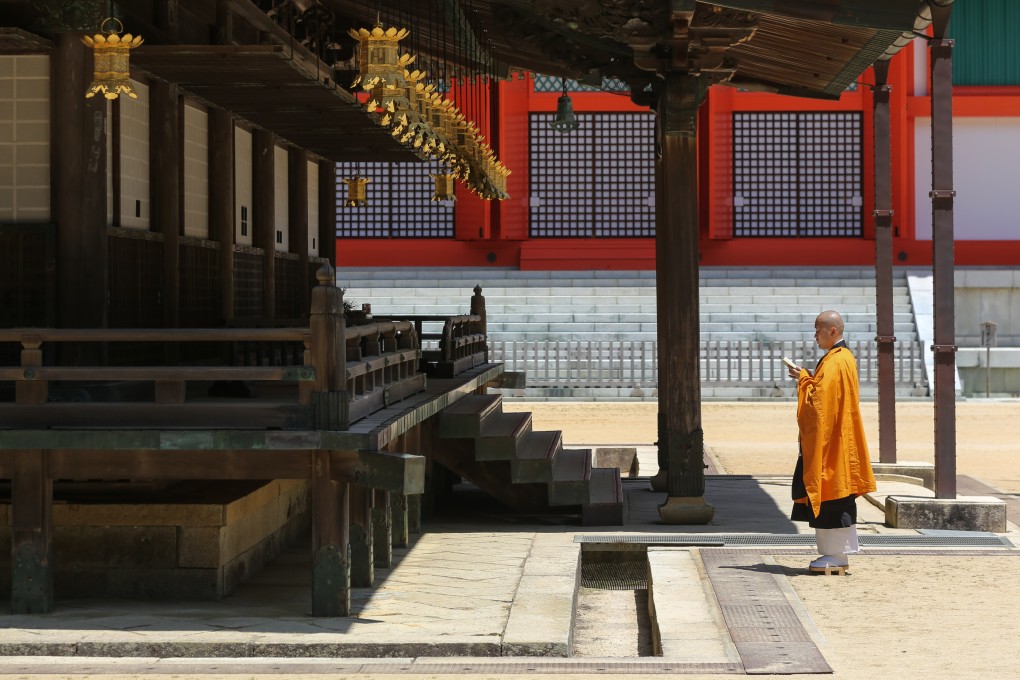 A Buddhist monk prays at a temple on Mount Koya in Japan’s Wakayama prefecture. About two in five people interviewed for the survey said their sense of trust in religion had declined in the past two years. Photo: Shutterstock