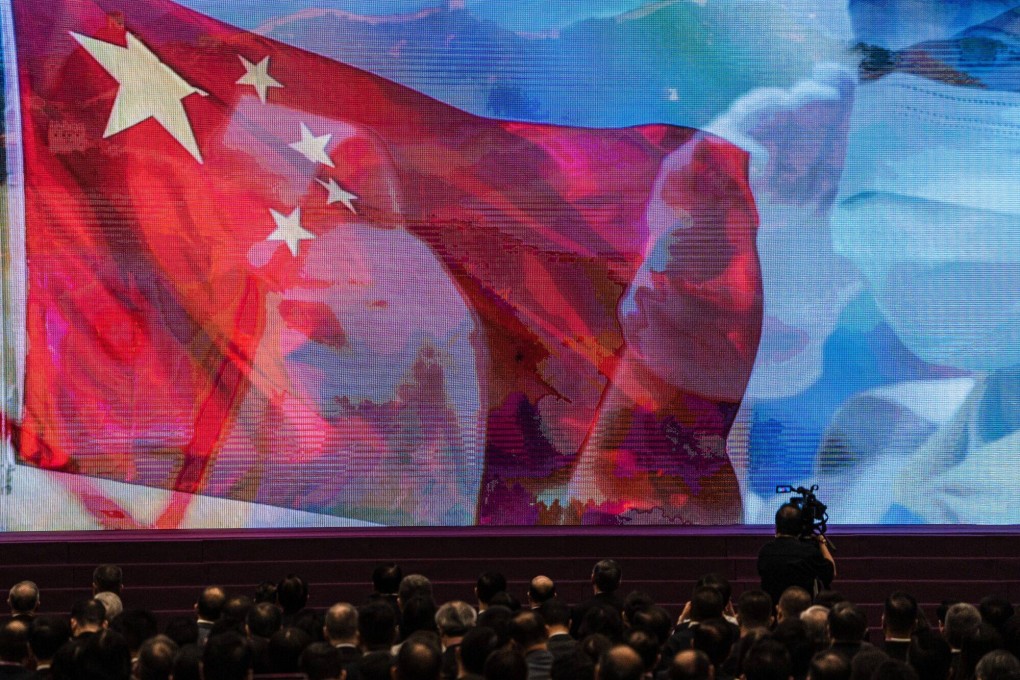 A screen showing the Chinese flag during the National Security Education Day opening ceremony in Hong Kong on April 15. China’s unique political system, characterised as whole-process democracy, ensures people’s aspirations become the will of the country. Photo: Bloomberg