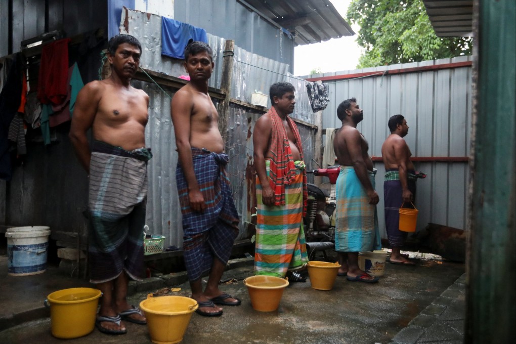 Migrant workers queuing to use one of four toilets shared among 104 construction workers in Kuala Lumpur, Malaysia last year. Photo: Reuters