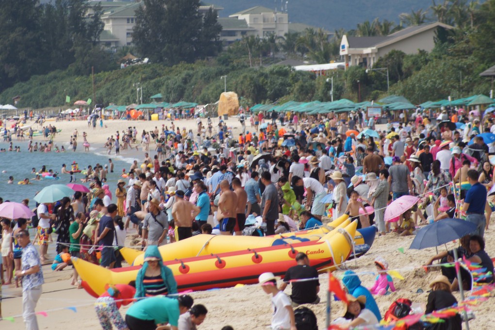 Chinese tourists at a beach in Sanya, Hainan province. The end of travel restrictions is likely to boost the fortunes of travel companies in China. Photo: Visual China Group via Getty Images