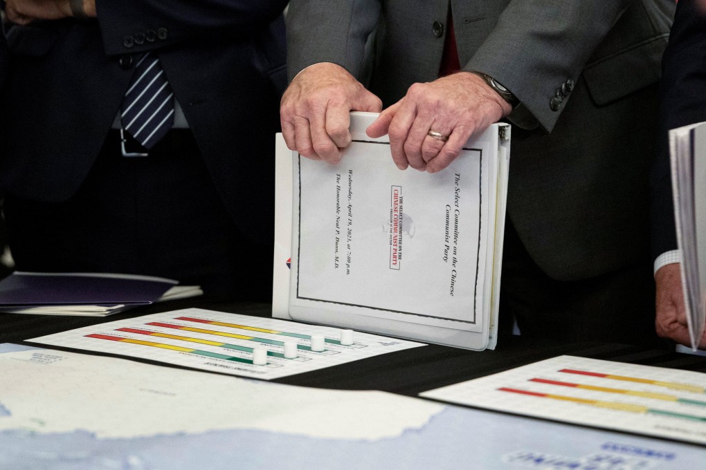 A representative holds a binder full of information about the war game simulation during a House Select Committee meeting in Washington on the Strategic Competition Between the United States and the Chinese Communist Party. Photo: Reuters