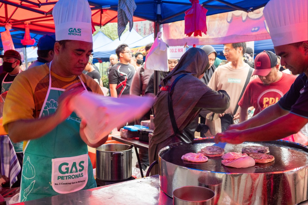 A Ramadan bazaar seller flipping roti canai at the Kampung Baru Ramadan bazaar in Kuala Lumpur.  Photo: SCMP / Hadi Azmi