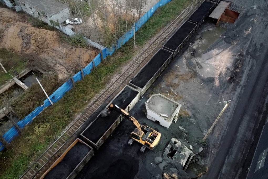 An excavator loads coal onto a train in Pingdingshan in central Henan province. All listed central state-owned Chinese enterprises are expected to disclose ESG information by year end. Photo: Reuters