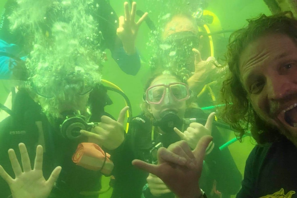 Joseph Duturi greets students scuba diving outside his undersea habitat. The man known as Dr Deep Sea is on a mission to live underwater for 100 days to understand the body’s limits and inspire children to get into science. Photo: University of South Florida
