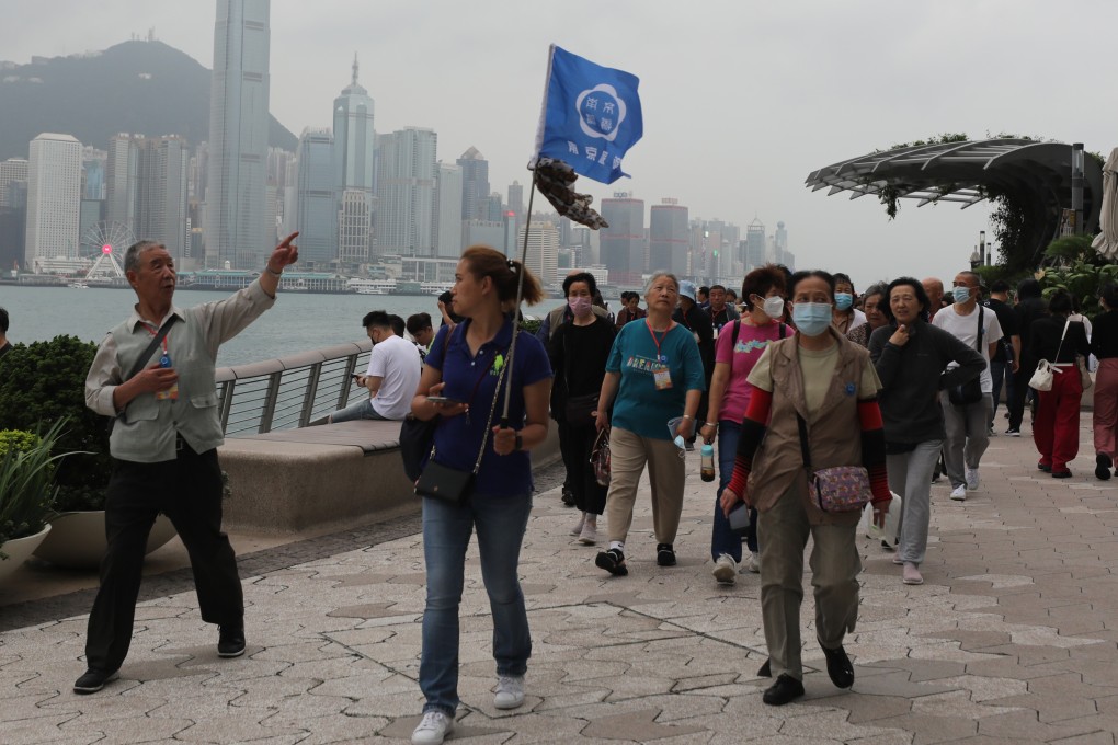 Tourist take a walk along the waterfront in Tsim Sha Tsui. Photo: Xiaomei Chen