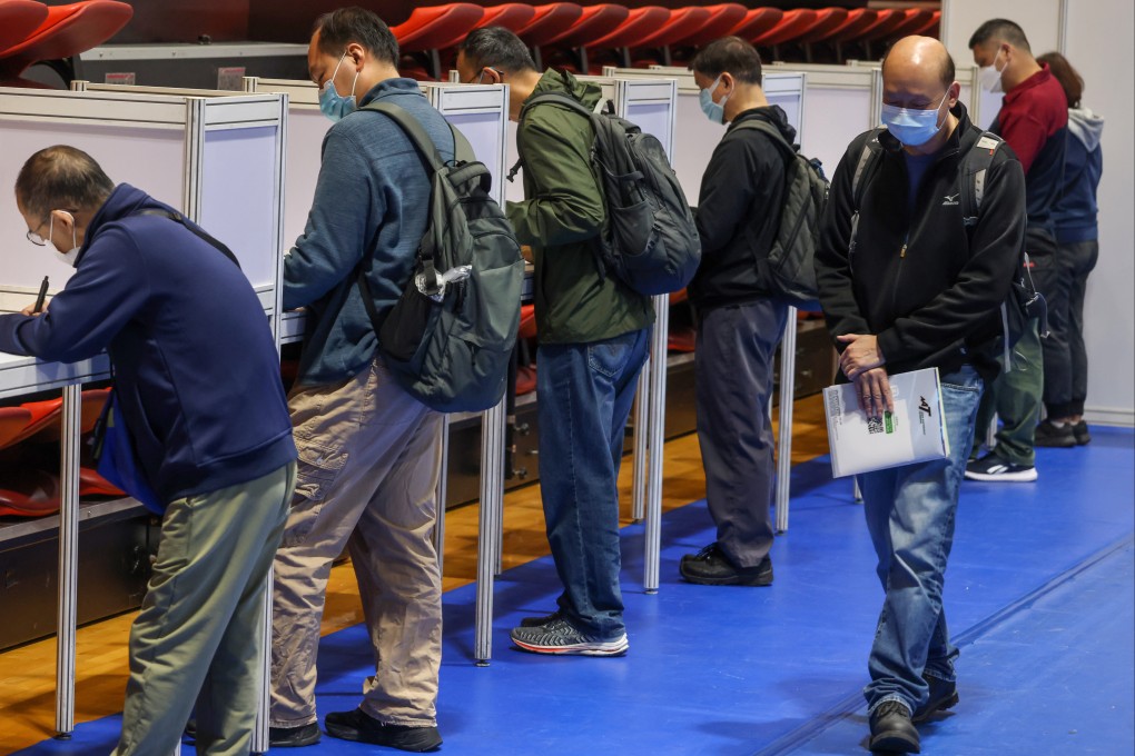 Residents fill out forms at a job fair organised by the Labour Department. Photo: May Tse