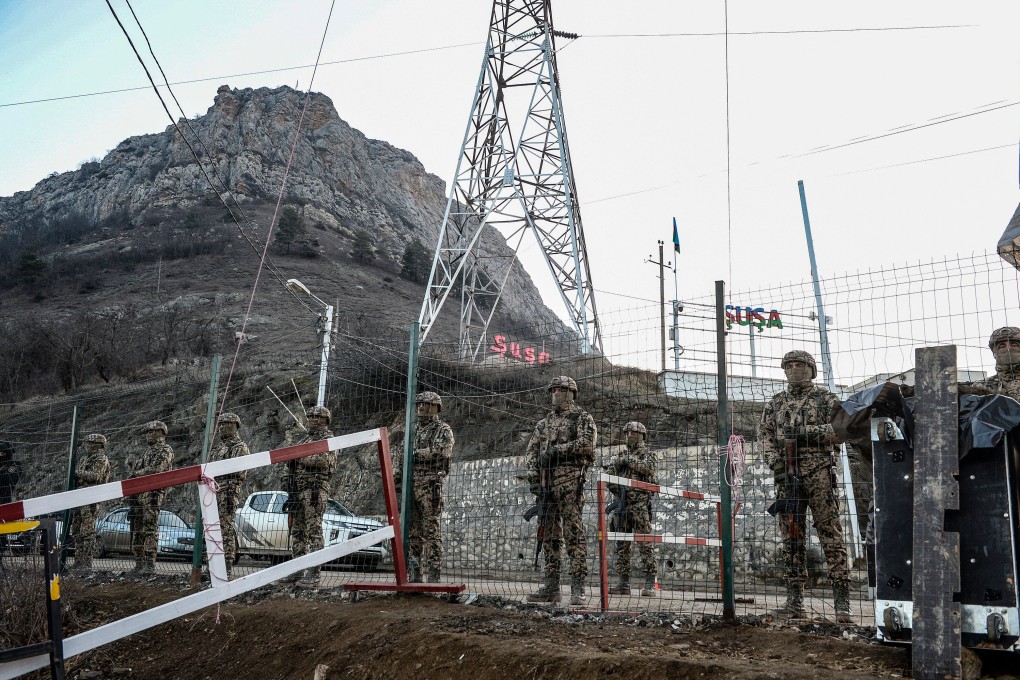 Azerbaijani servicemen stand guard at a checkpoint at the Lachin corridor, the Armenian-populated breakaway Nagorno-Karabakh region’s only land link with Armenia, in 2022. Photo: AFP / Getty Images / TNS
