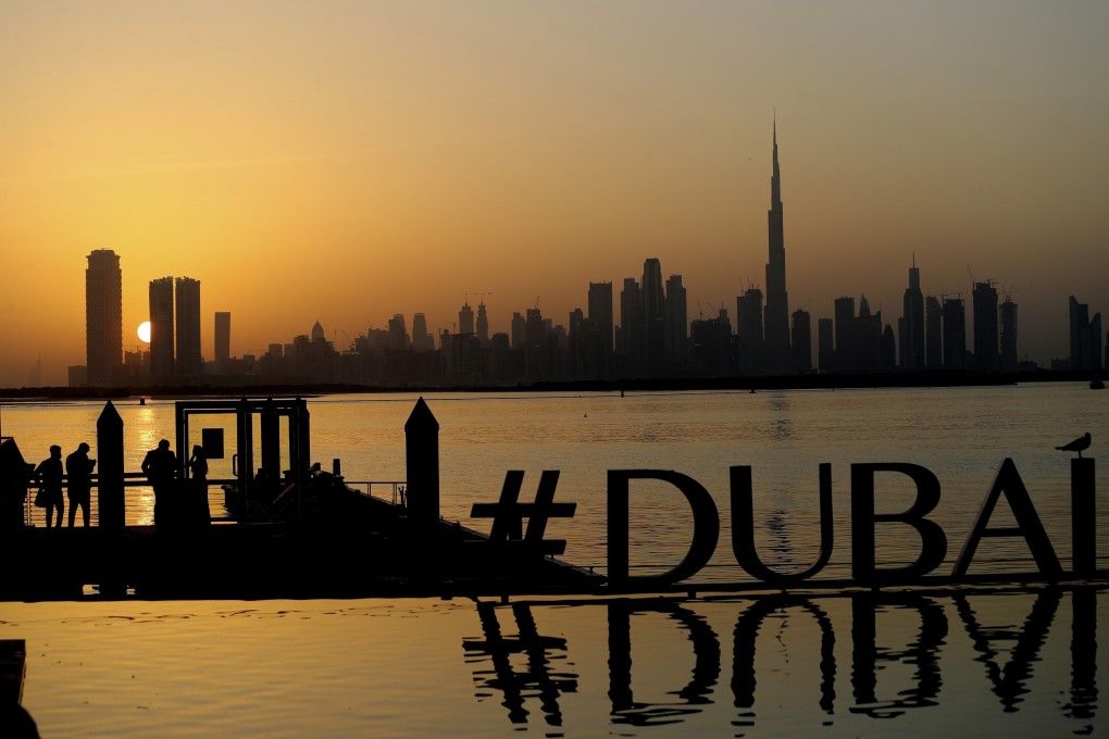 People enjoy the sunset with the view of the skyline and the world’s tallest tower, Burj Khalifa, in Dubai. Photo: AP Photo