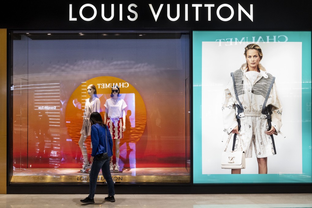 A shopper passes a display window at a French luxury fashion brand Louis Vuitton store in Hong Kong on June 9, 2021. The city’s role as a destination for luxury shoppers from the mainland is under threat. Photo: Getty Images