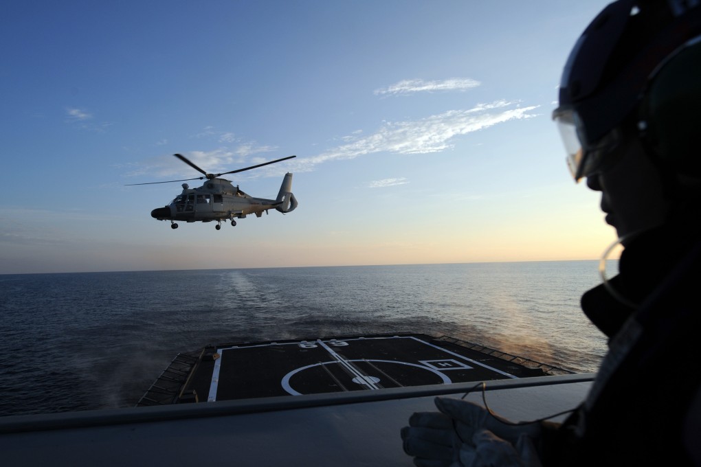 A Chinese naval helicopter lands on the deck of a Singapore frigate during a 2015 joint exercise held in the South China Sea. Photo: Xinhua