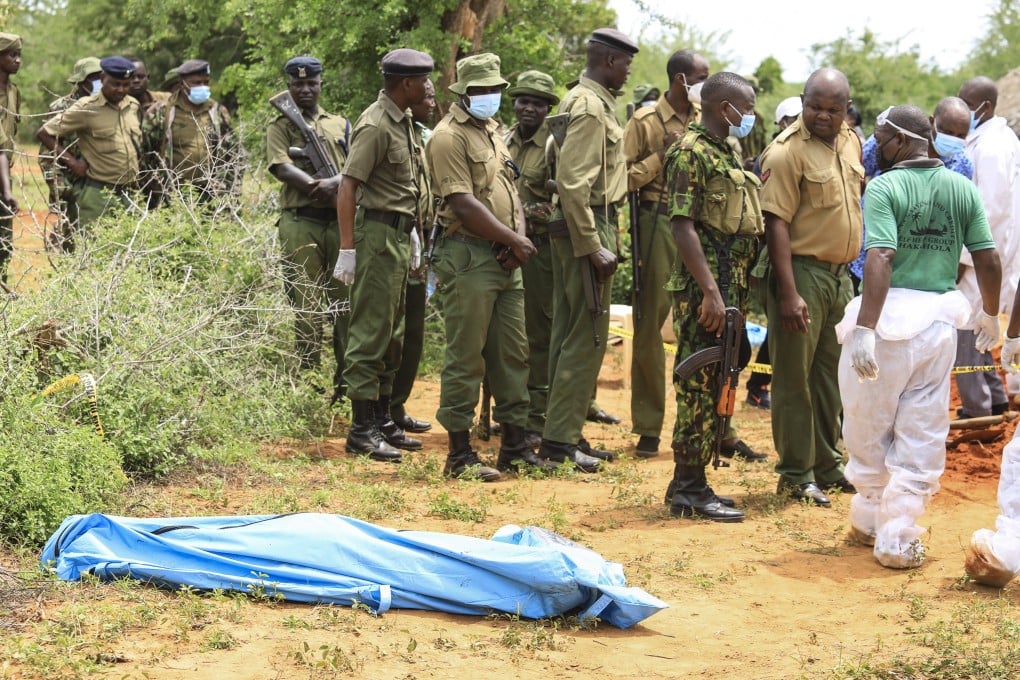 Kenyan homicide detectives and forensic experts from the Directorate of Criminal Investigations examine exhumed bodies from several shallow mass graves of suspected members of a Christian cult after starving themselves to death. Photo: EPA-EFE