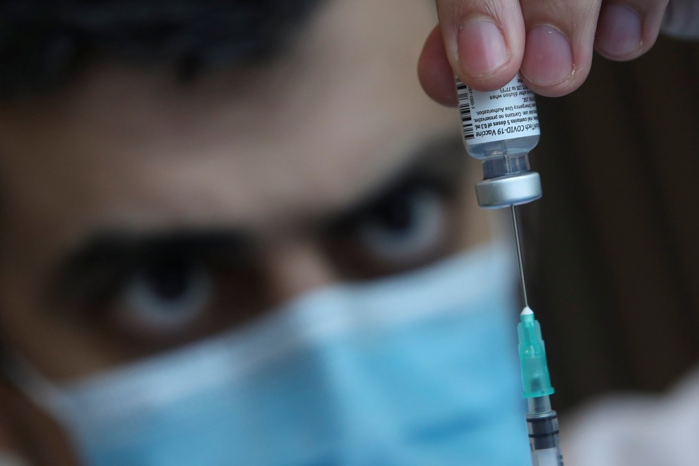 A medical worker fills a syringe with a Pfizer-BioNTech vaccine dose in Brussels. Photo: Reuters