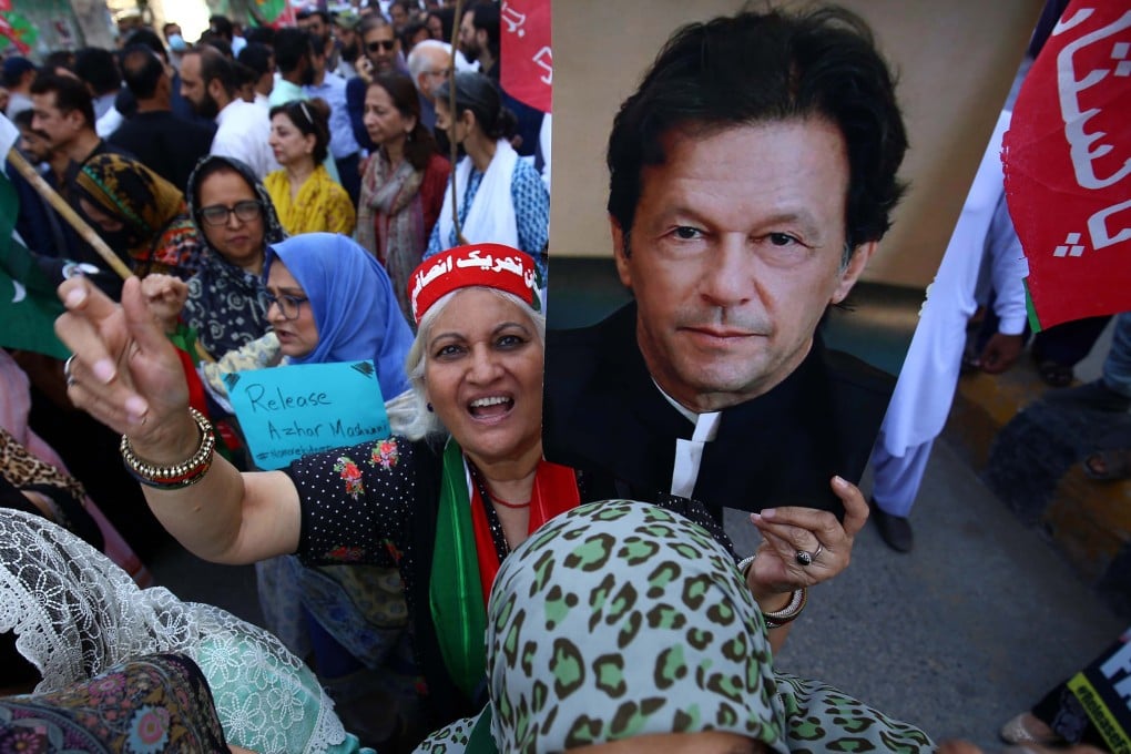 A supporter of opposition party Pakistan Tehreek-e-Insaf (PTI) holds a poster of its chairman Imran Khan, the nation’s former leader, during a rally in March. Photo: EPA-EFE
