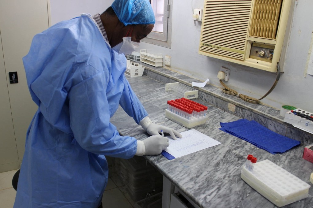 An undated photo shows a staff member at the National Public Health Laboratory in Khartoum, Sudan. Photo: Handout via Reuters