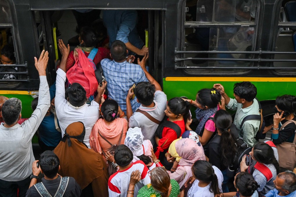 Commuters board an overcrowded bus at a bus stop in New Delhi. India is expected to overtake China as the world’s most populous country, but it faces several challenges before it can get the full benefit of its demographic dividend. Photo: AFP