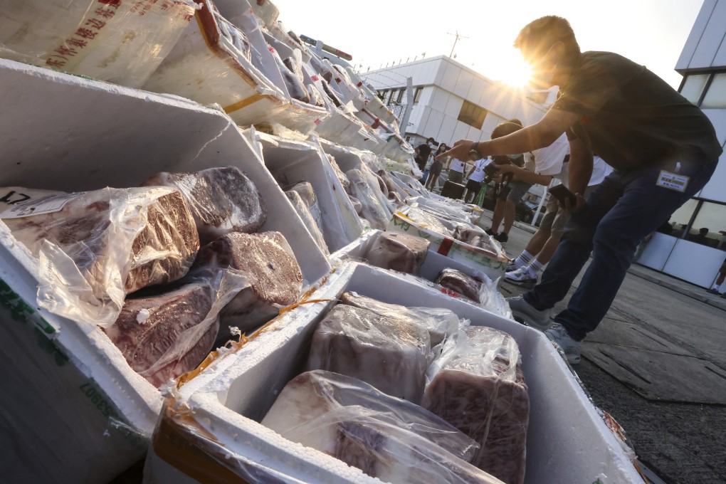 Hong Kong customs officers examine smuggled meat. Photo: Jonathan Wong
