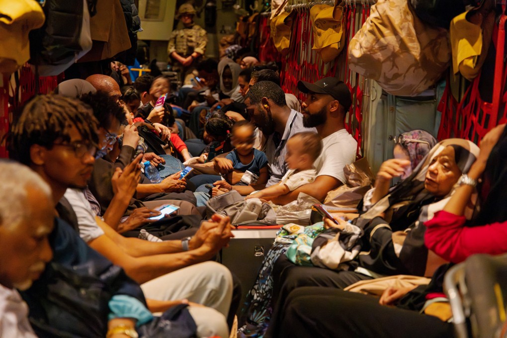 British nationals sit inside an RAF aircraft, after being evacuated in Khartoum, Sudan. Photo: Reuters