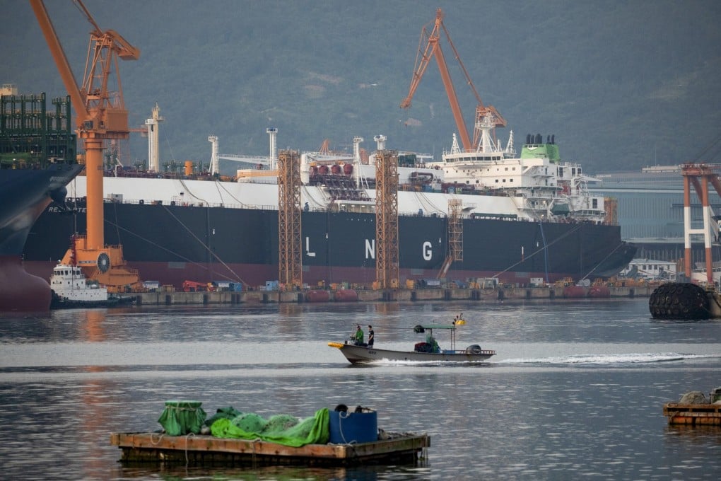 A fishing boat sails past liquefied natural gas (LNG) tankers under construction at the Daewoo Shipbuilding & Marine Engineering Co. shipyard in Geoje, South Korea. Qatar has signed a deal worth around $20 billion with South Korean shipbuilders to help cement its position as the world’s largest LNG producer. Photo: Bloomberg