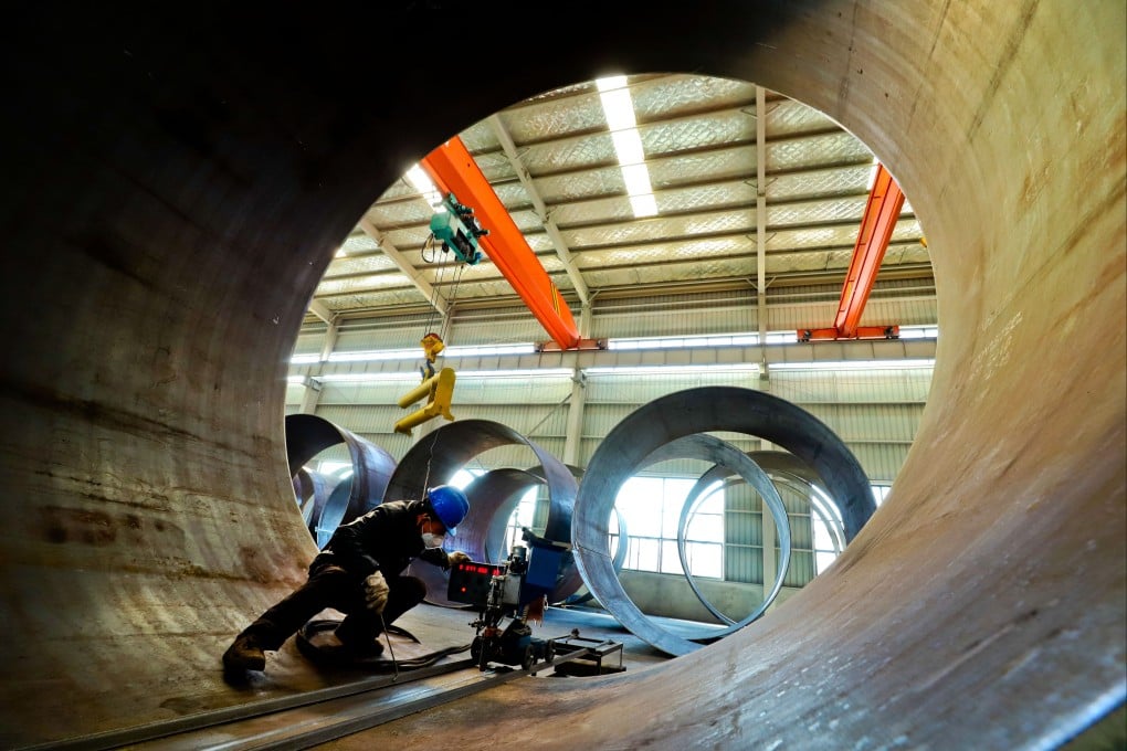 A welder works at a wind turbine factory in Gansu, China, on March 1. The world needs to switch from fossil fuels to renewables. Photo: Getty Images