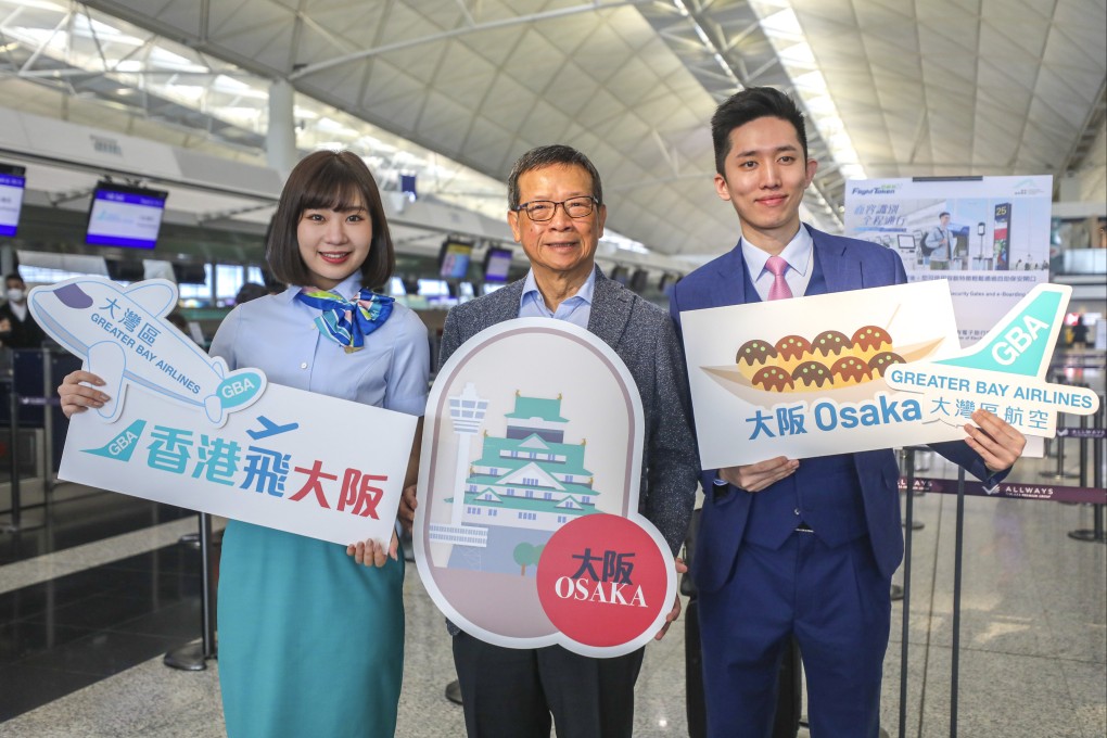 Greater Bay Airlines CEO Stanley Hui Hon-Chung (centre) with cabin crew members Candy Lau Ka-chun and Jordan Tseung Tat celebrate the carrier’s first flight to Osaka. Photo: Xiaomei Chen