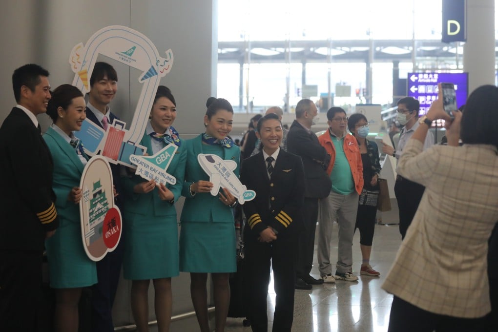 GBA crew members welcome passengers at the check in for the airline’s inaugural flight to Osaka in Japan. Photo: Xiaomei Chen