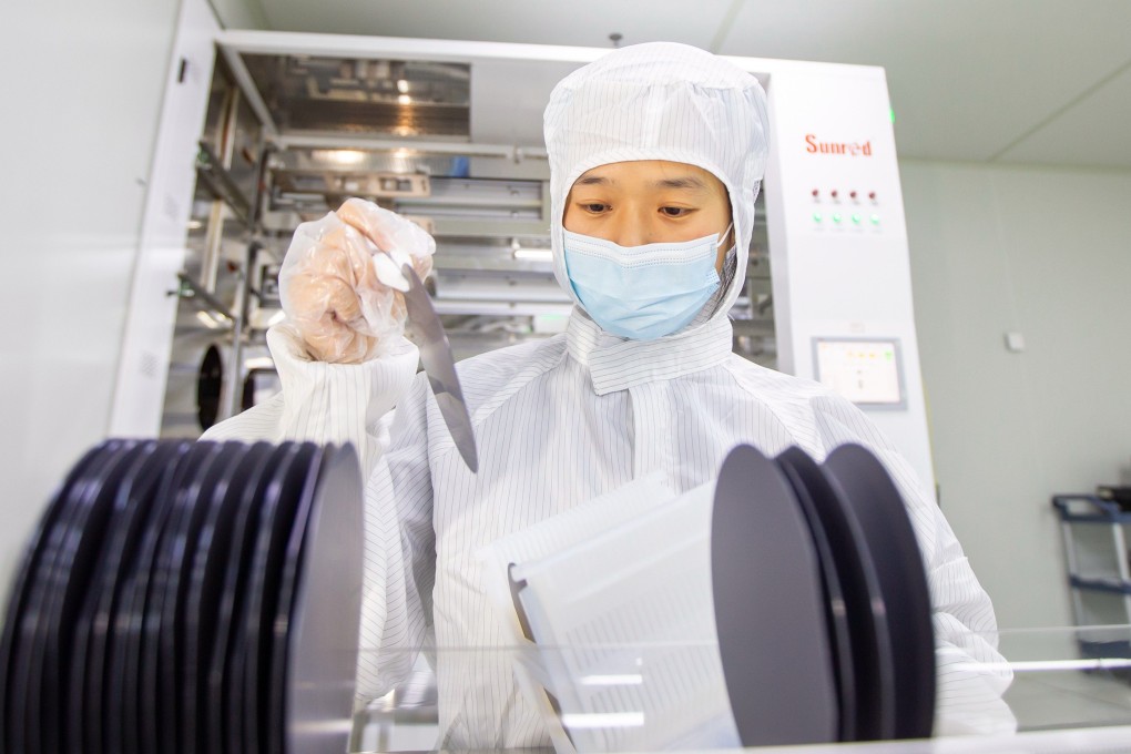 A workers holding semiconductor chips at a microelectronics enterprise in Hai’an, Jiangsu Province of China. Photo: VCG via Getty Images