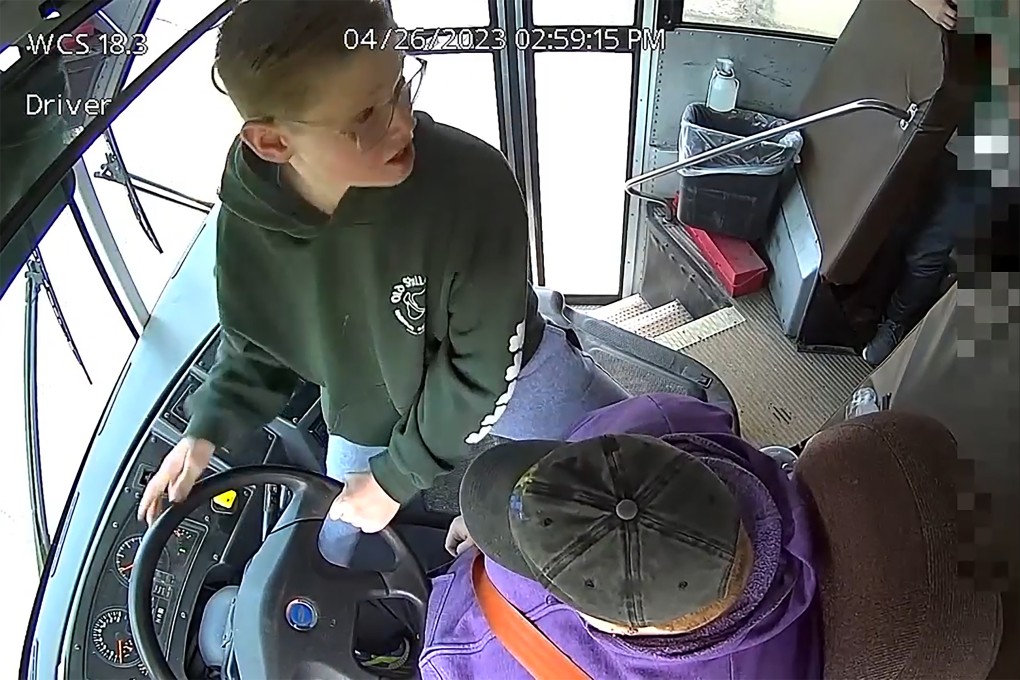 Student Dillon Reeves grabs the steering wheel on his school bus and hit the brakes after the driver passed out Wednesday. Photo: Warren Consolidated Schools via AP