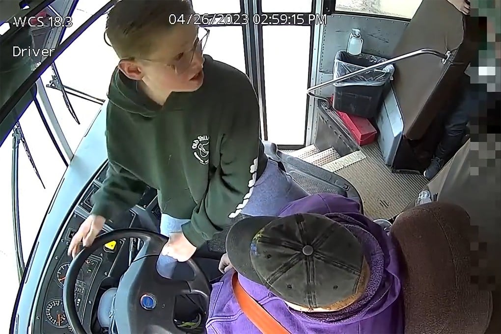 Student Dillon Reeves grabs the steering wheel on his school bus and hit the brakes after the driver passed out Wednesday. Photo: Warren Consolidated Schools via AP