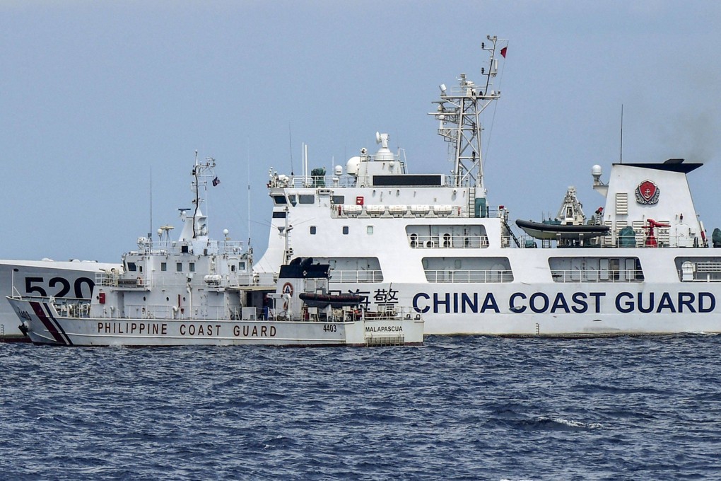 The Philippine coast guard vessel BRP Malapascua, front, manoeuvres as a Chinese coast guard ship cuts its path at Second Thomas Shoal in the Spratly Islands in the disputed South China Sea. Photo: AFP