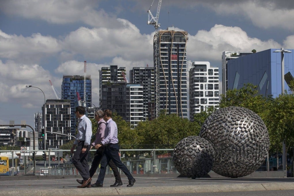 People pass a residential building under construction in Brisbane, Australia, on April 17. Home values nationwide rose 0.5 per cent in April, the second straight month-on-month increase. Photo: Bloomberg