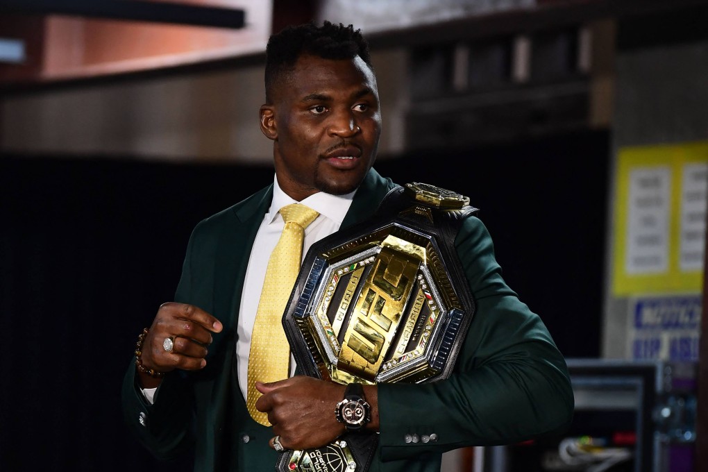 Francis Ngannou holds the UFC heavyweight title as he speaks to the media after defeating Ciryl Gane Gane at UFC 270. Photo: AFP