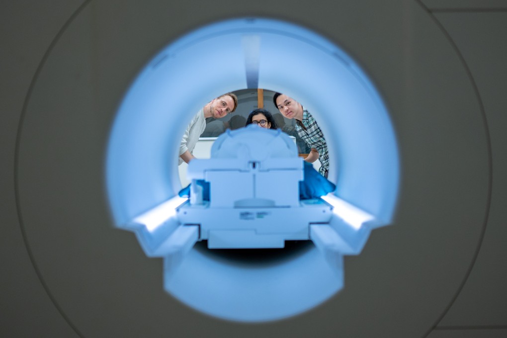 Alex Huth (left), Shailee Jain (centre) and Jerry Tang (right) prepare to collect brain activity data in the Biomedical Imaging Center at The University of Texas at Austin. Photo: Nolan Zunk/University of Texas at Austin