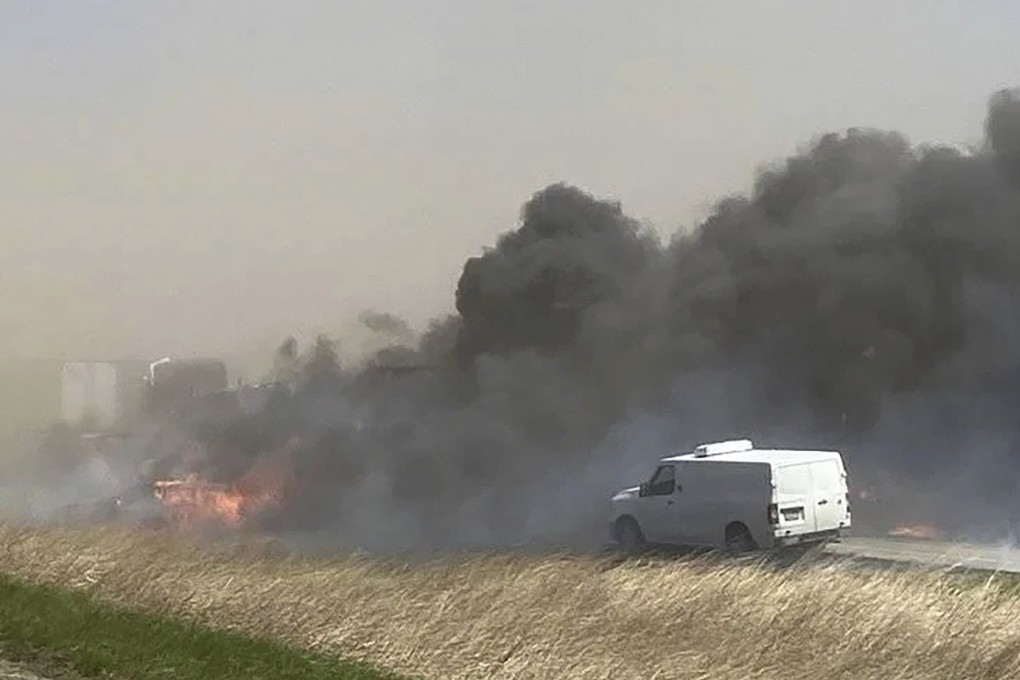 Smoke billows after crashes involving dozens of vehicles shut down a highway in Illinois on Monday. Photo: WICS TV via AP