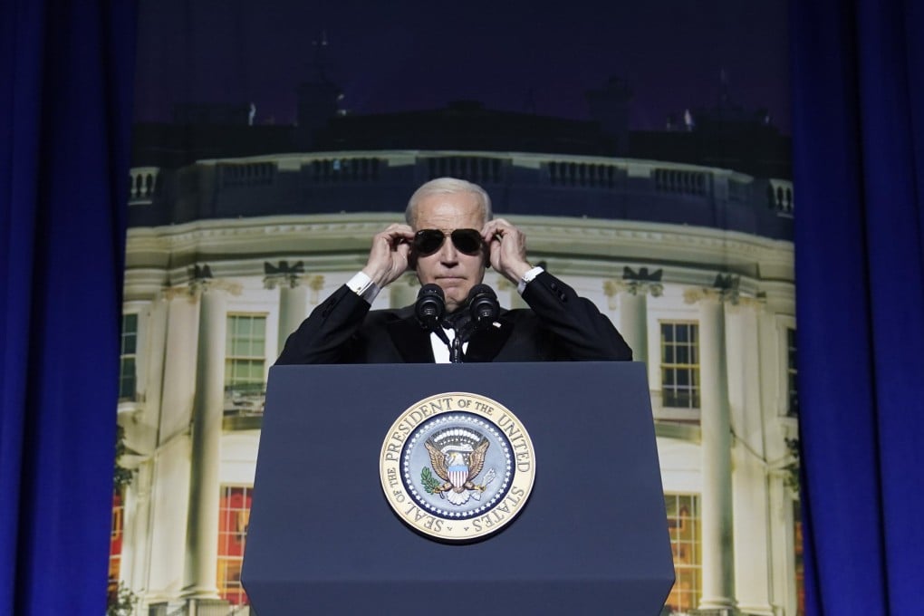 US President Joe Biden puts on sunglasses during the White House Correspondents’ Association dinner in Washington on Saturday. Photo: AP