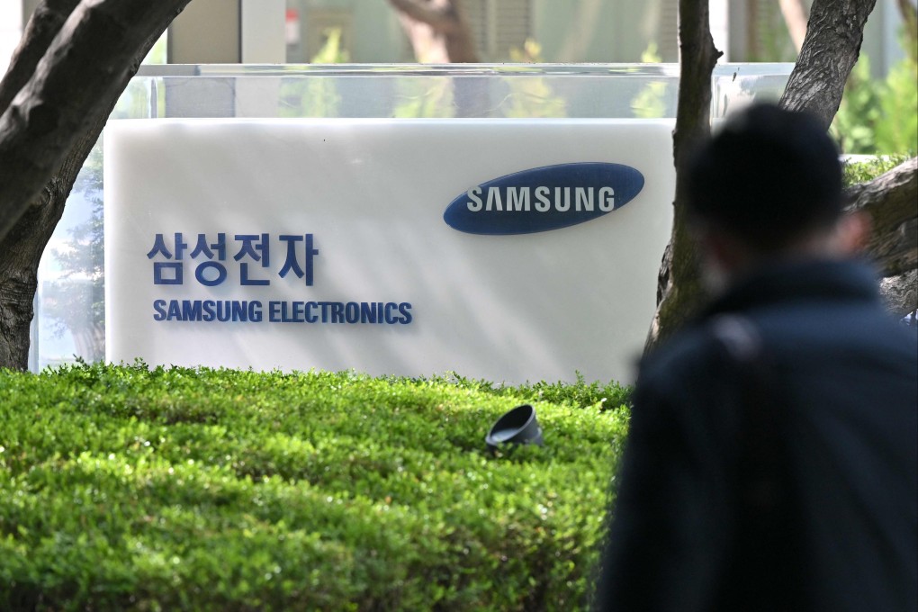 A man walks past a signboard of Samsung Electronics displayed outside the company’s Seocho building in Seoul on April 7, 2023. Photo: AFP