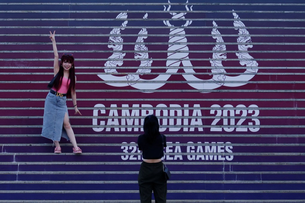 Visitors take photos in front of the logo of the 32nd Southeast Asian Games in front of the Morodok Techo National Stadium in Phnom Penh. Photo: Reuters