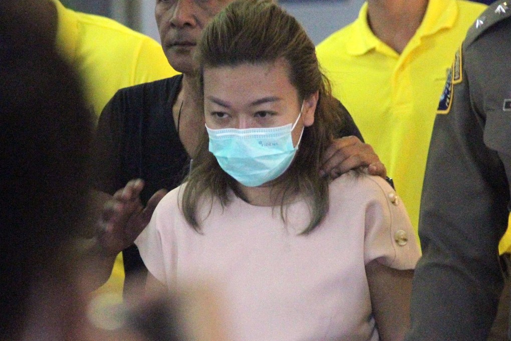 Police officers escort Sararat Rangsiwuthaporn to the criminal court in Bangkok on April 26, 2023. Photo: EPA-EFE
