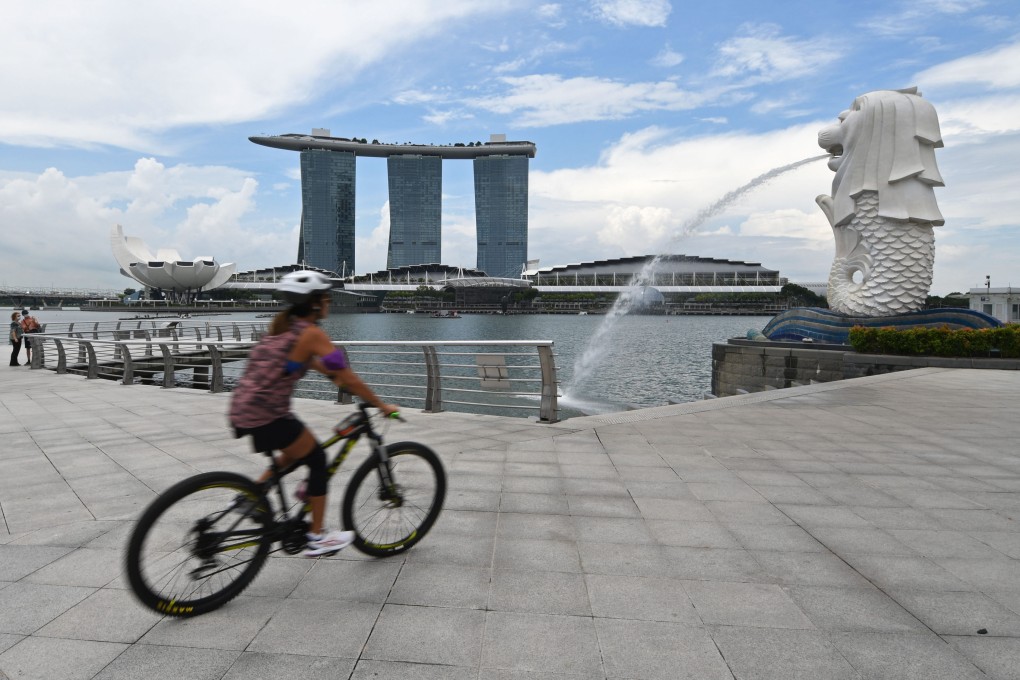 A cyclist cycles at the Merlion Park in Singapore’s Marina Bay. Photo: Xinhua