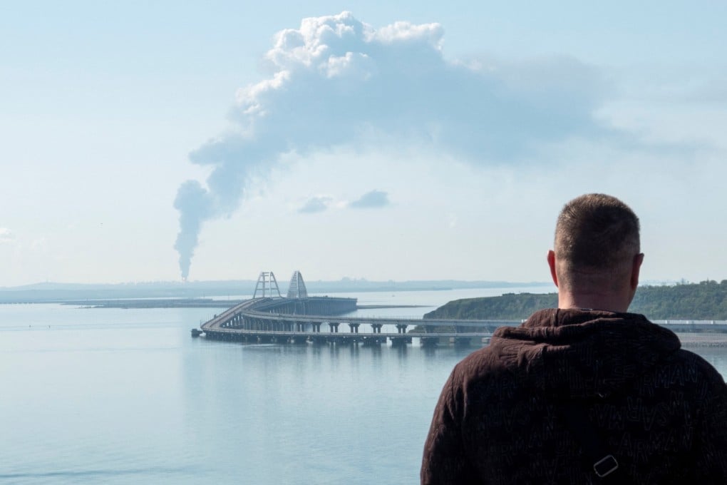 A view across the Kerch Strait shows smoke rising above a fuel depot near the Crimean bridge in the village of Volna in Russia’s Krasnodar region. Photo: Reuters