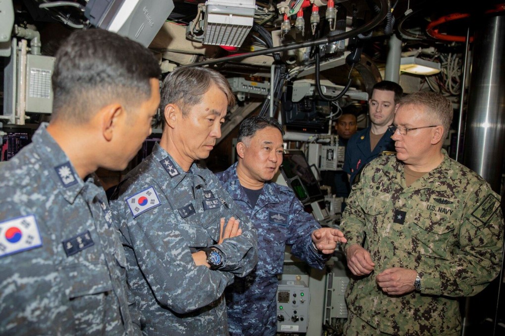 Japanese Maritime Self-Defence Force Vice Admiral Tateki Tawara (centre right) speaks with US Navy Rear Admiral Rick Seif (right) and Republic of Korea Navy Rear Admiral Lee Su-Youl (centre left) aboard the submarine USS Maine on April 18. Photo: US Navy